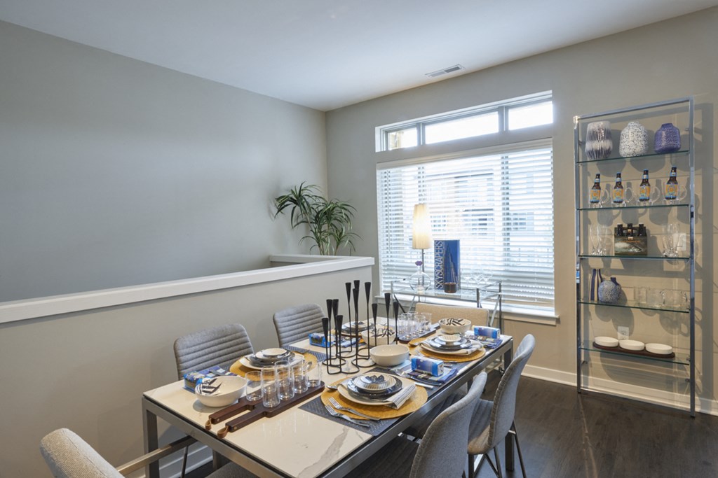 a dining room with a table and chairs and a large window
