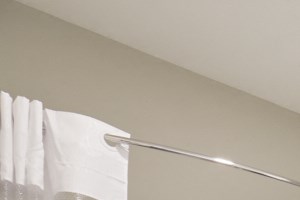 a bathroom with white cabinets and a white toilet and a shower