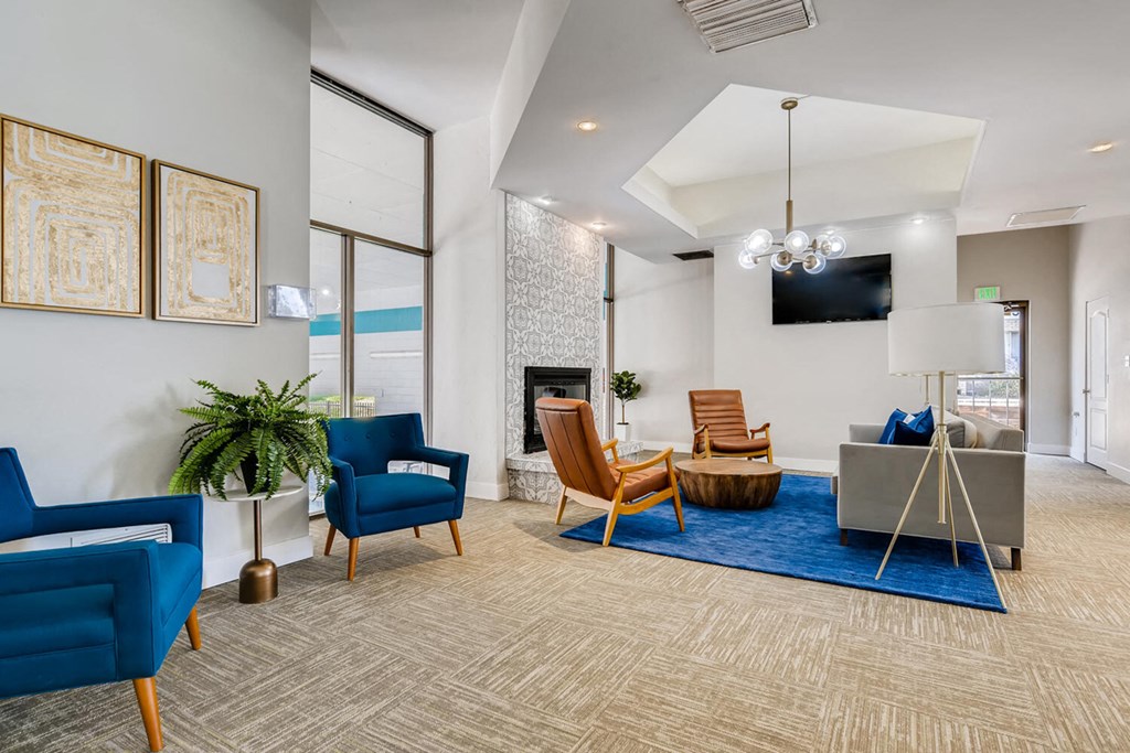a living room with blue furniture and a fireplace
