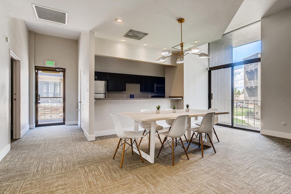 a dining room with a white table and chairs