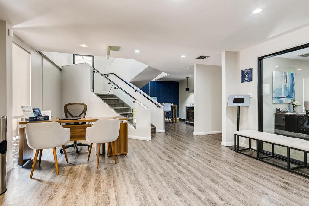 a dining room with a table and chairs and a staircase