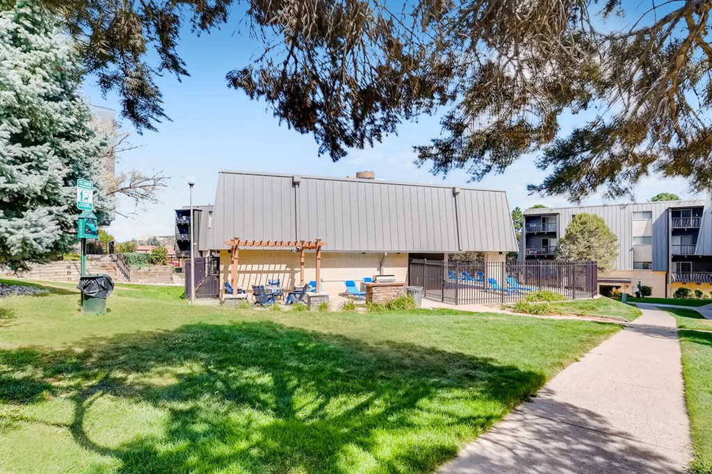 the building in which the school is located is shown with a sidewalk and grass
