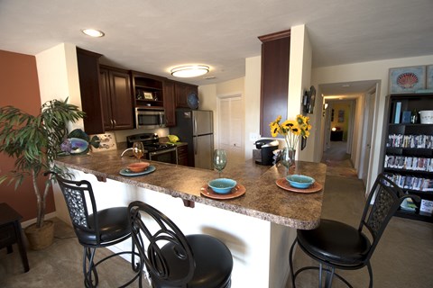 a kitchen and dining room with a granite counter top