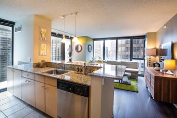 Full granite Kitchens with Contemporary Wood Cabinetry