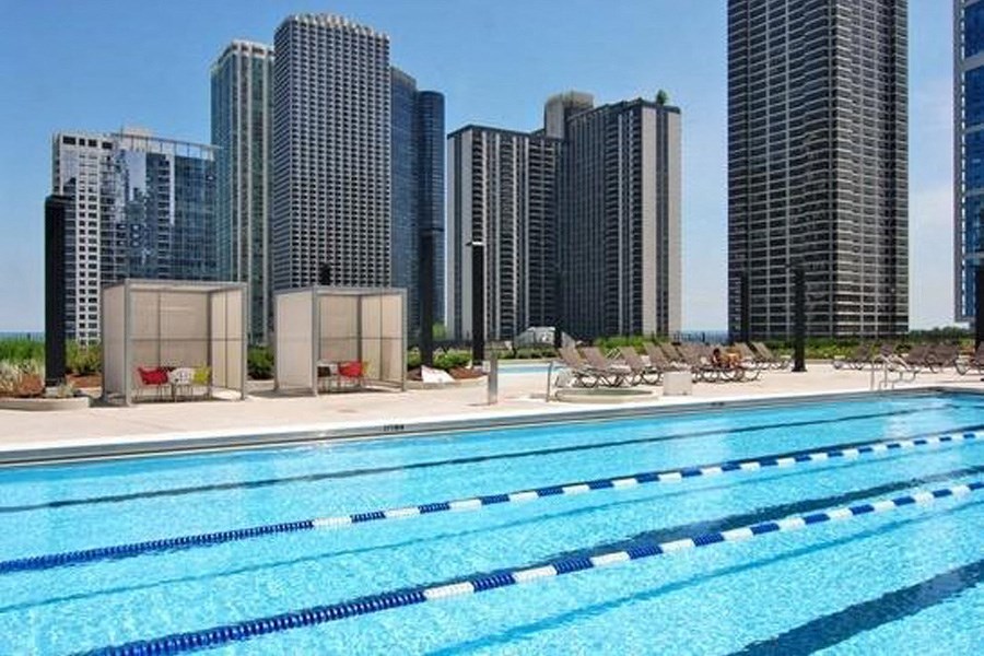 a swimming pool with a city skyline in the background