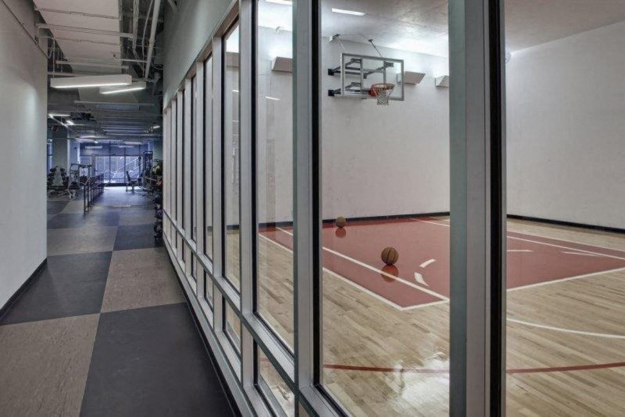 a basketball court in a building with glass doors