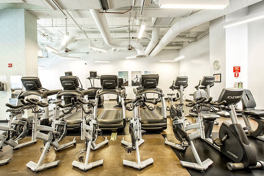a gym full of treadmills and other exercise equipment
