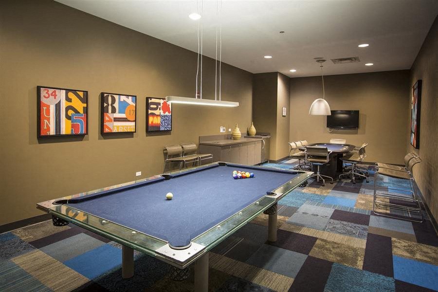 a game room with a pool table and a tv