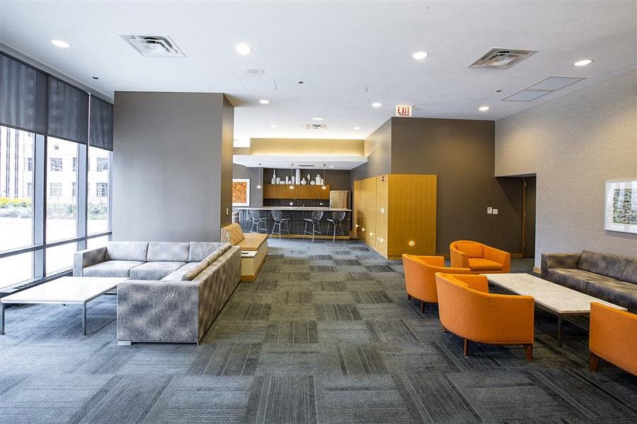 a lobby with couches and chairs and a bar