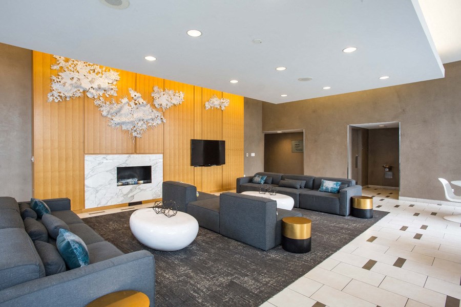 a living room with couches and chairs and a fireplace