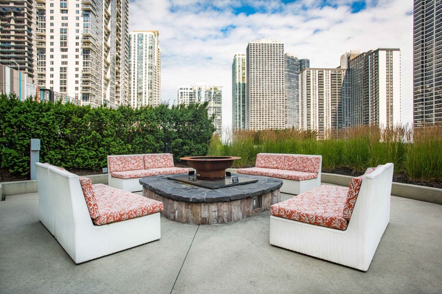 a seating area with a fire pit on a patio