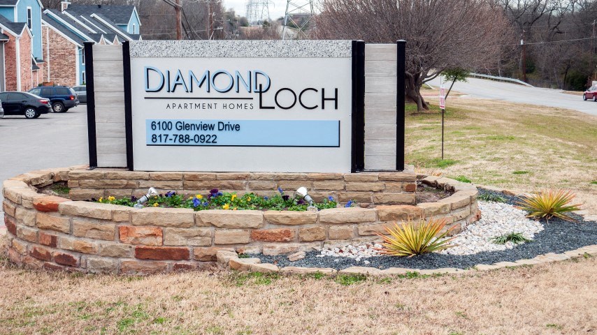 a sign for the diamond loch sign in front of a building