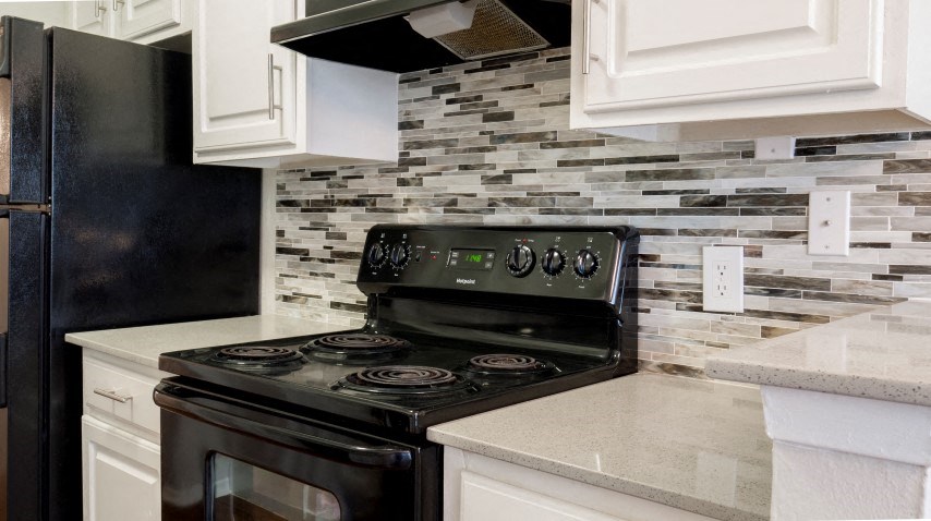 a kitchen with a stove and a refrigerator