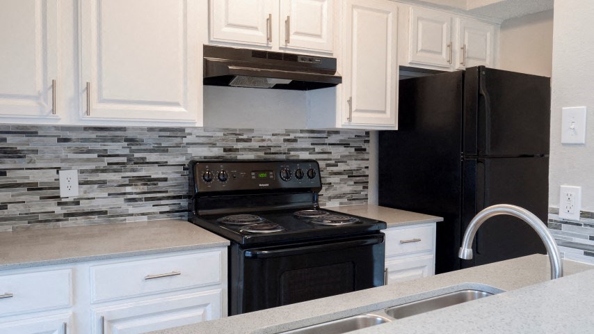 a kitchen with a stove and a refrigerator