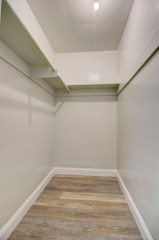 a empty room with white walls and a wood floor