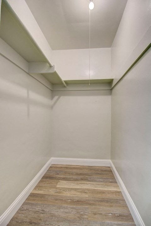 a empty room with white walls and a wood floor
