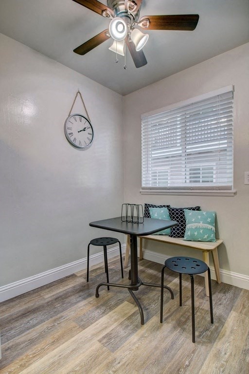 a dining room with a table and a clock on the wall