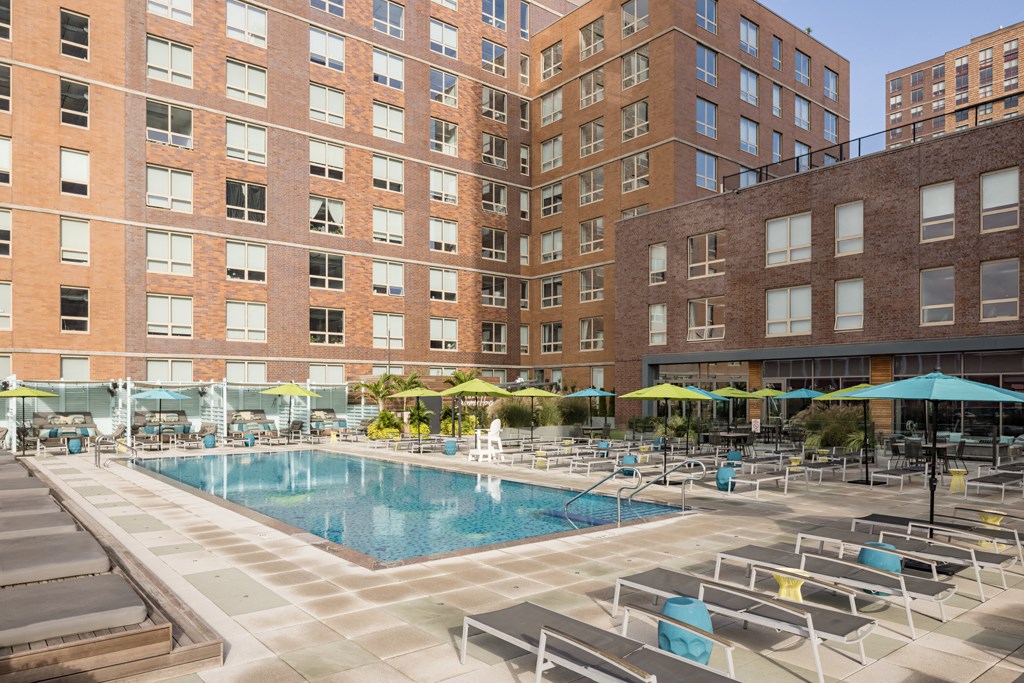 a swimming pool in front of a tall building