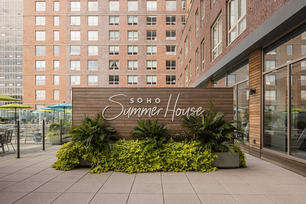 a sign for the summer house in front of a building