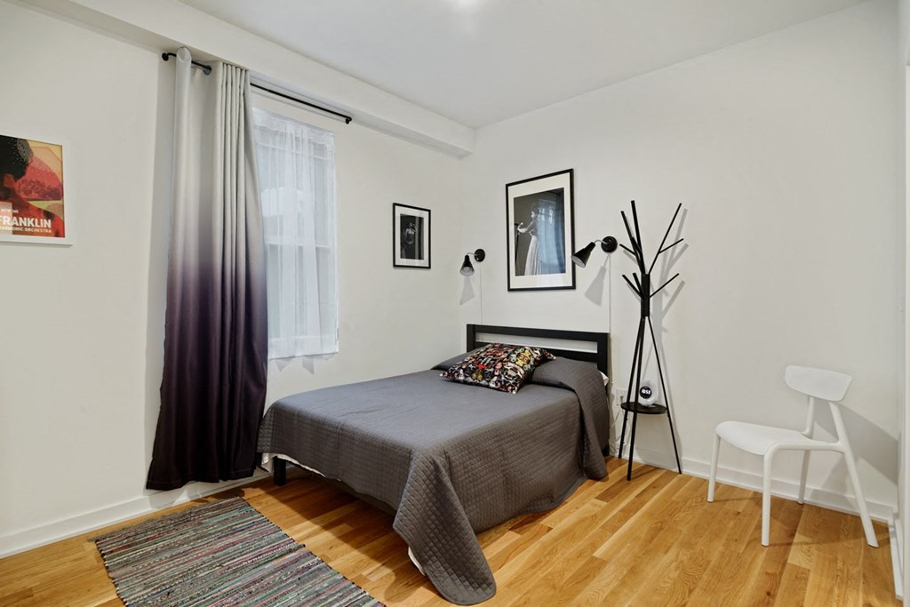 a bedroom with a bed and a large window