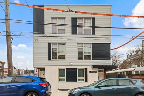 a white and black building with cars parked in front of it