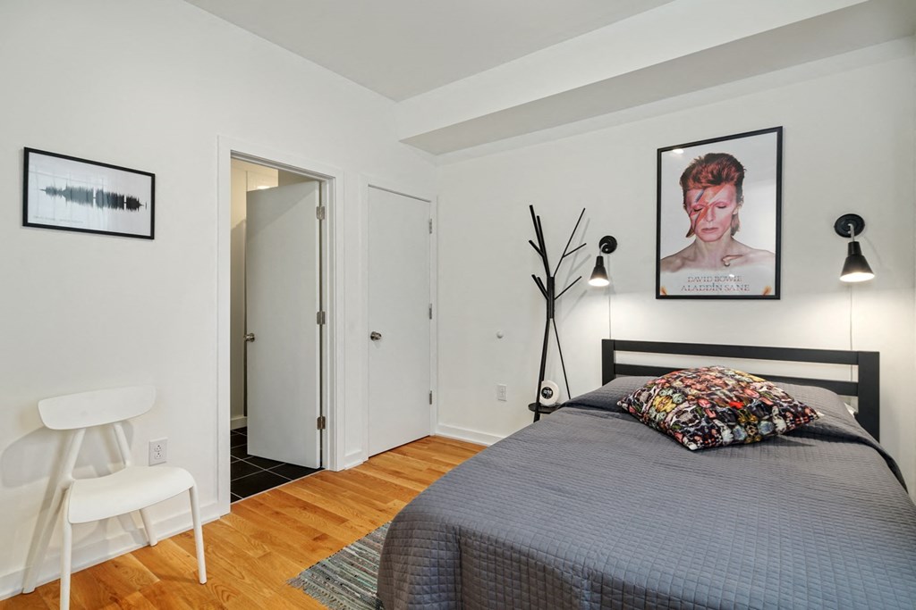 a bedroom with a bed and a door to a bathroom