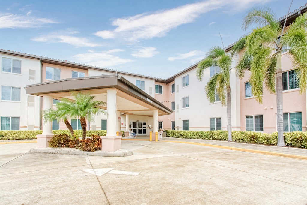 a large building with palm trees in front of it