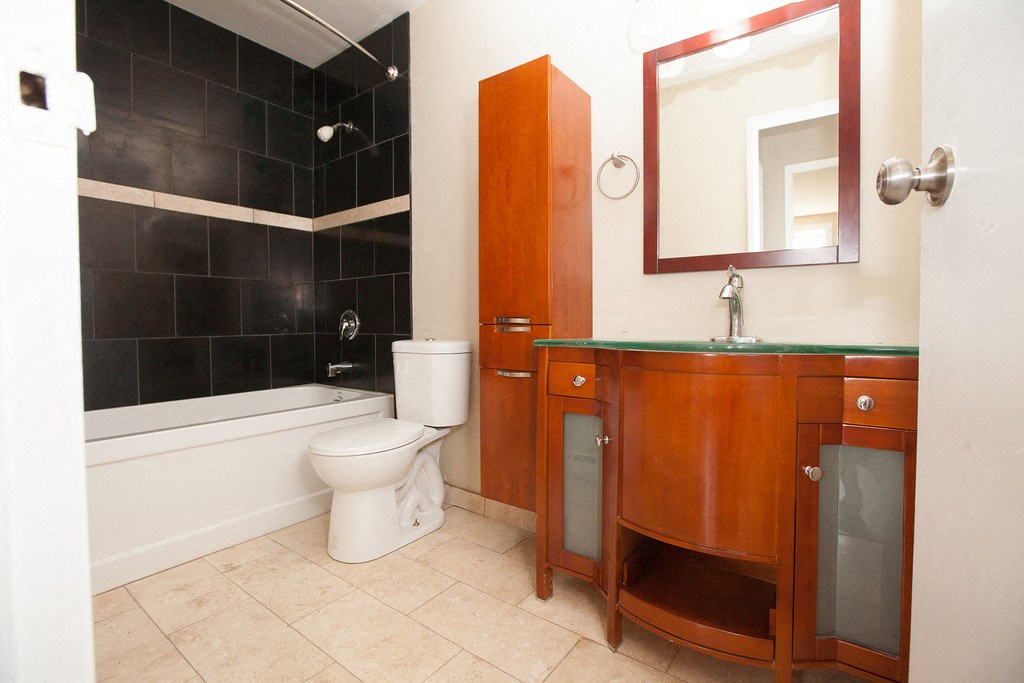 a bathroom with a toilet and a sink and a tub