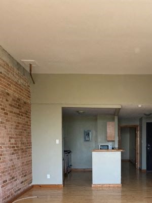an empty living room with a wooden floor