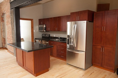 a kitchen with stainless steel appliances and wooden cabinets