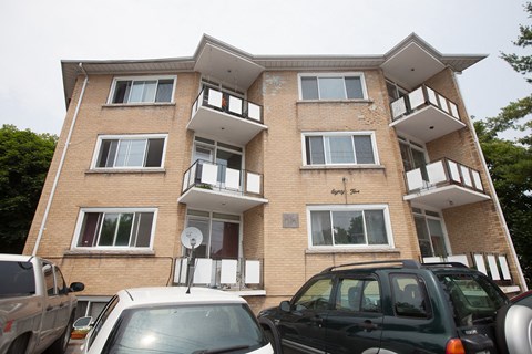 a apartment building with cars parked in front of it