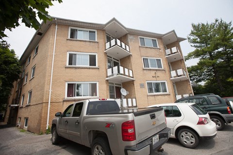 a apartment building with cars parked in front of it