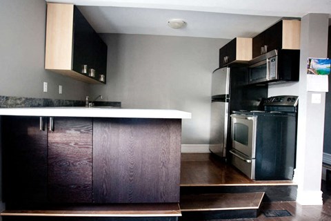 a kitchen with a stove refrigerator and a sink