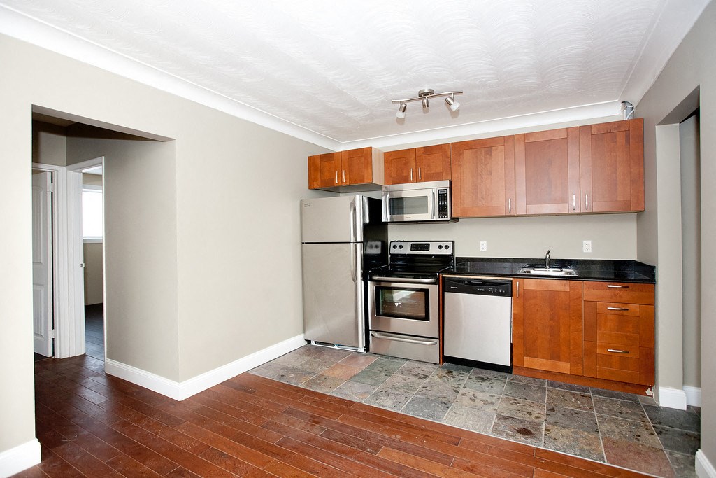 a kitchen with stainless steel appliances and wooden cabinets