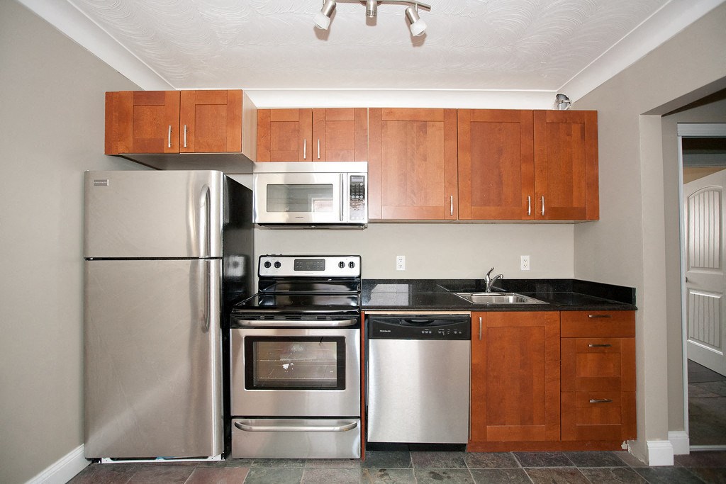 a kitchen with stainless steel appliances and wooden cabinets