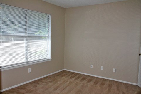 a room with a large window and a wooden floor