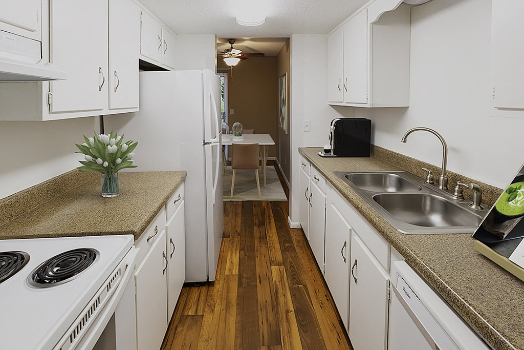 a kitchen with white cabinets and counters and a sink