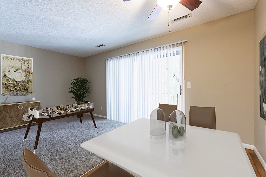 a dining room with a white table and chairs and a large window