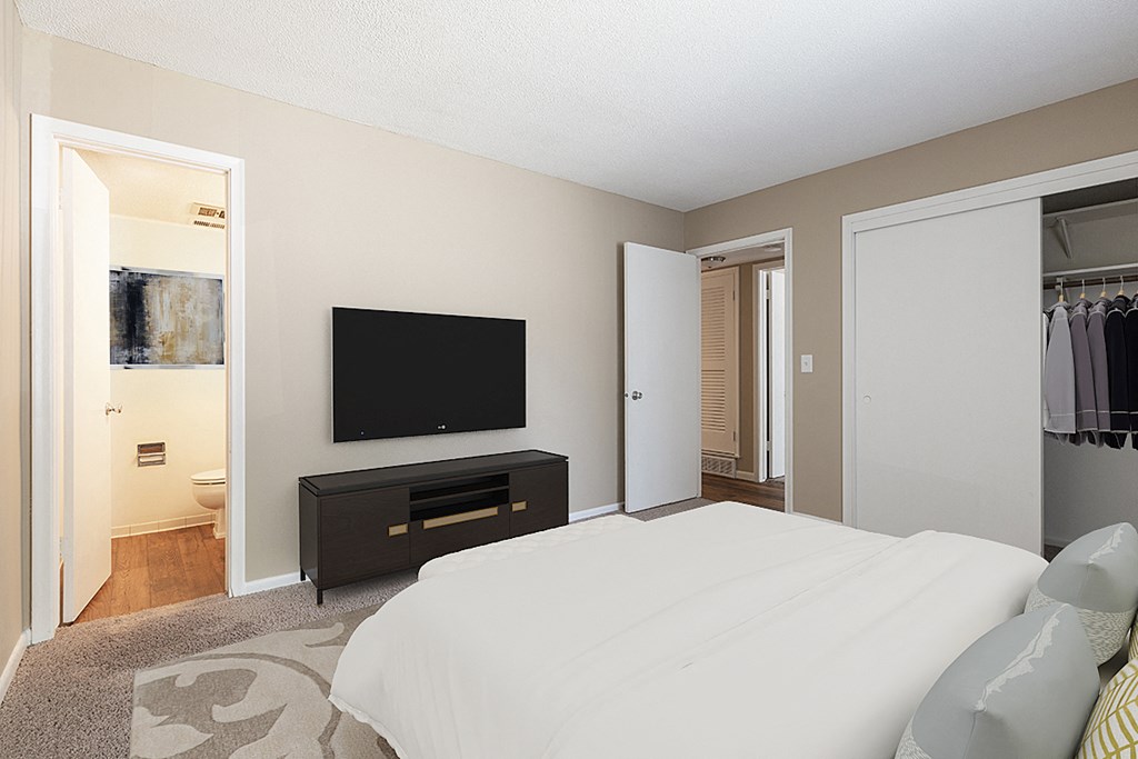 a bedroom with a large bed and a tv