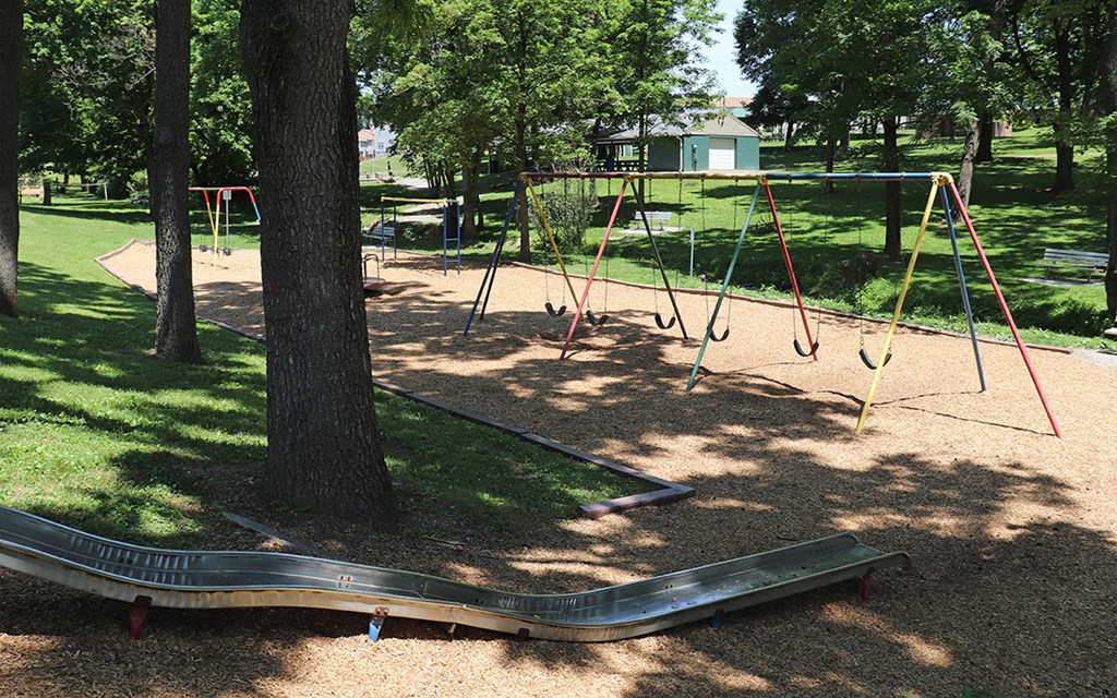 a childrens swing set in a park