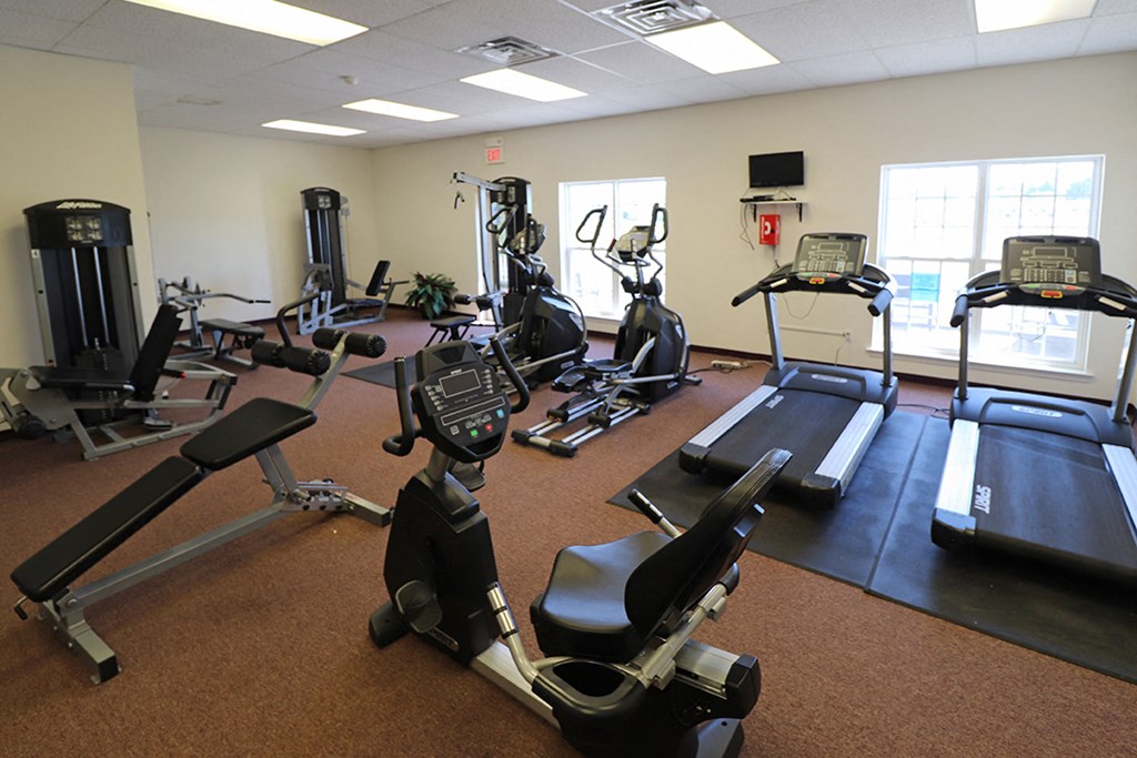a gym with various pieces of exercise equipment