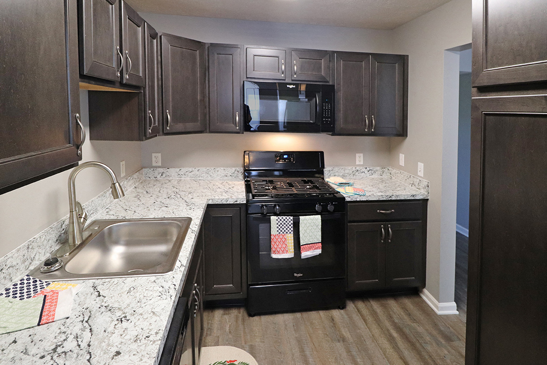 a kitchen with black appliances and granite counter tops