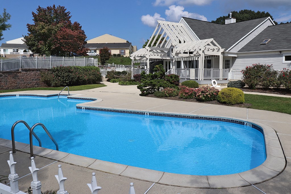 a swimming pool in front of a house