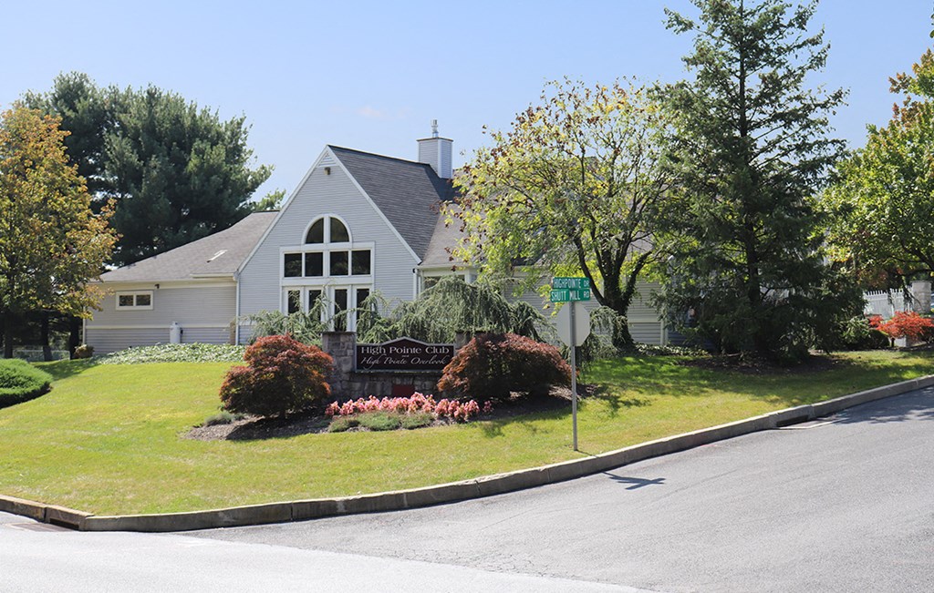 a house with a yard and a street sign in front of it