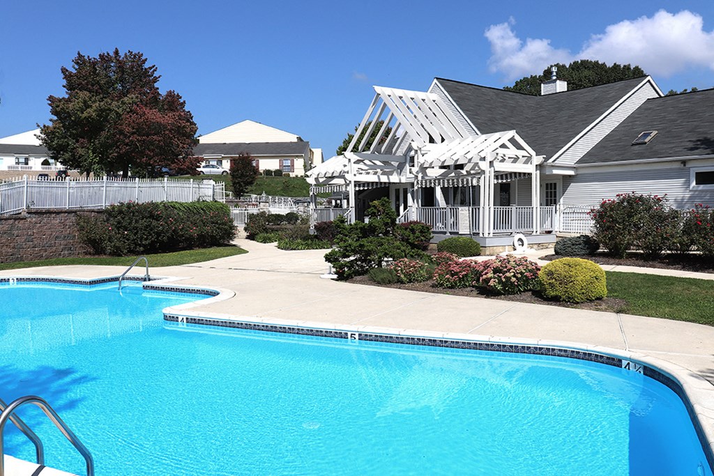 a large swimming pool in front of a house
