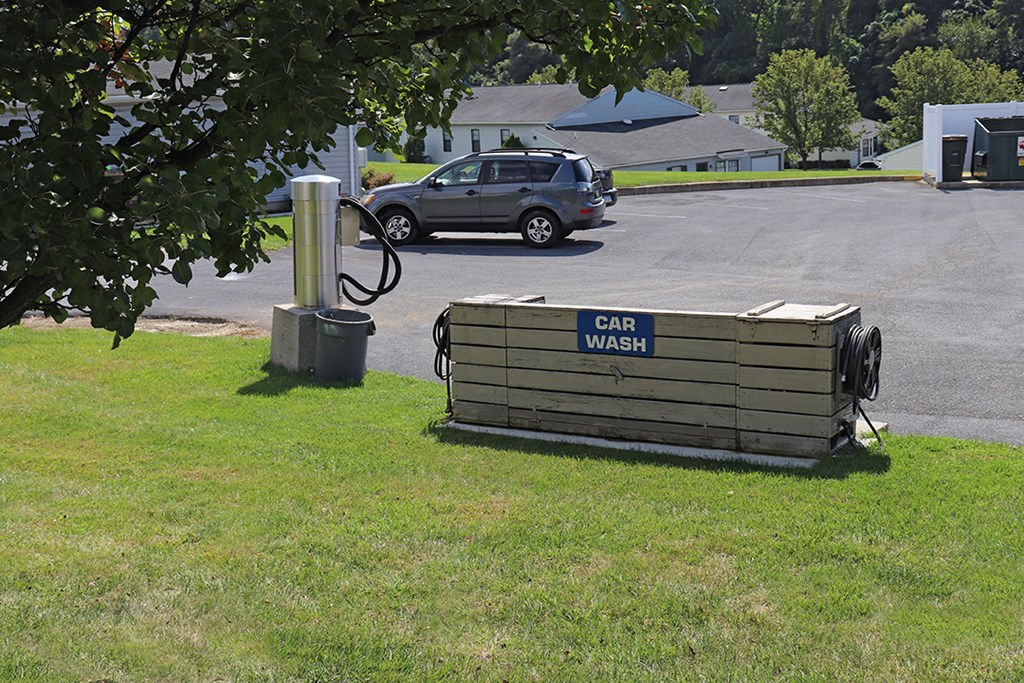 a car wash on the grass next to a parking lot
