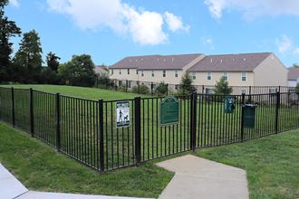 a fence with a sign on it in front of a house