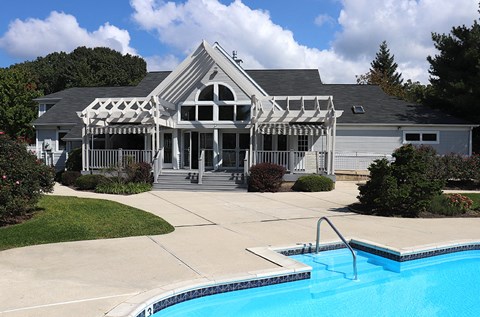 a house with a swimming pool in front of it