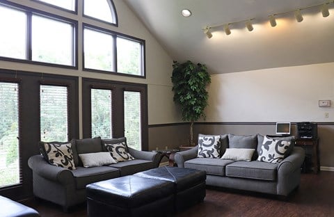 a living room with couches and a large window