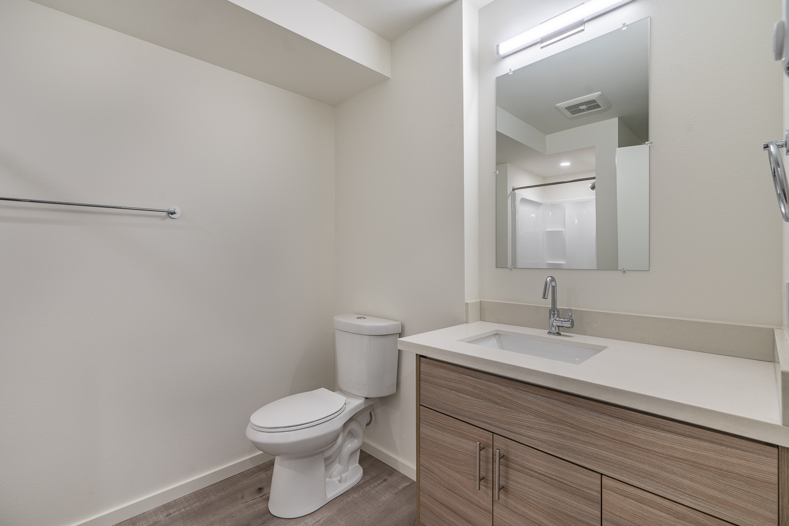 an empty bathroom with a toilet sink and mirror